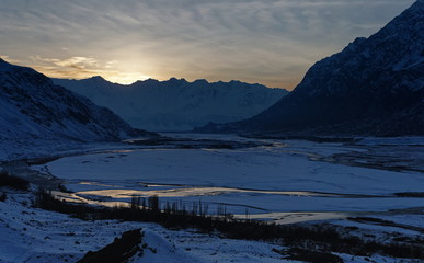 The winter sunset at the snow caped mountains