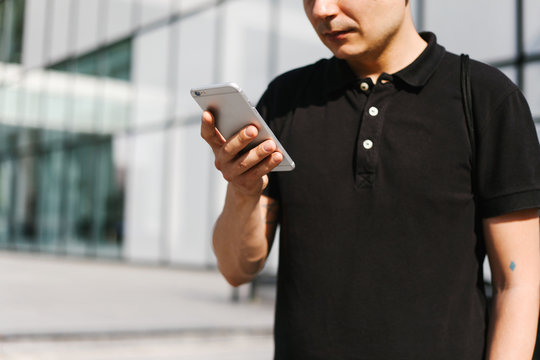 Male person hoding a smart phone