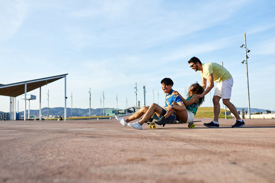 Friends riding longboard together.