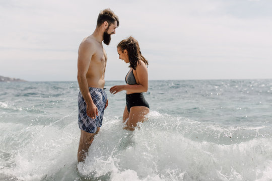 Couple standing together in the shallow water