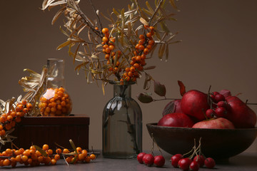 Autumn still life with sea buckthorn, hawthorn berries and apples. Composition of various berries and fruits in interior.  © vaitekune