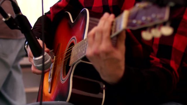 Man play guitar on a stage