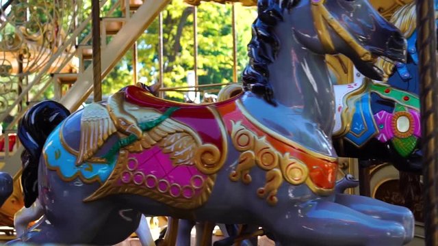 Retro vintage colorful circus carousel animal merry go round horse ride spinning in kids amusement park carnival funfair