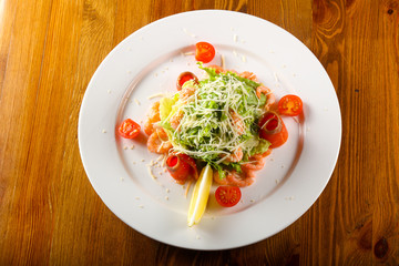 Caesar salad with shrimps and salmon