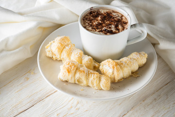 Morning breakfast, a cup of coffee and croissants
