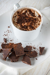 A cup of cocoa and chocolate closeup