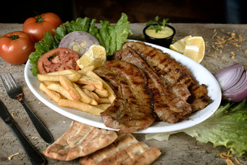 steak with potatoes in plate in restaurant