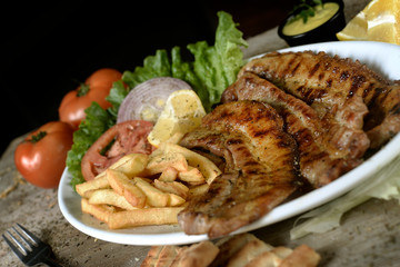 steak with potatoes in plate in restaurant