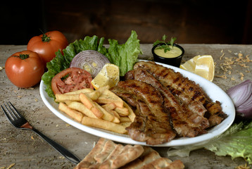 steak with potatoes in plate in restaurant