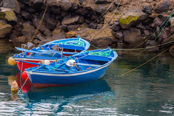 Obraz premium Two blue small fishing boats in greek style.