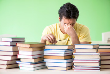 Student with too many books to read before exam