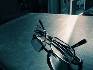 glasses on a dark background, shadow of the rim, metallic material