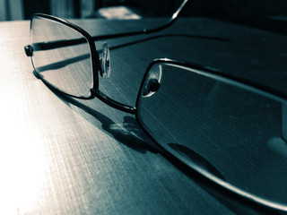 glasses on a dark background, shadow of the rim, metallic material