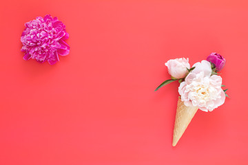 Waffle cone with white and pink peonies flower bouquet on pink red background