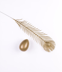 golden egg and golden feather, symbols of Easter
