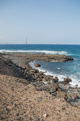 Vertical marine panorama. Background: ships and a wind turbine.