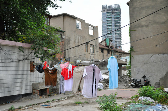 Laundry in an old backyard in Shanghai with skyscraper behind