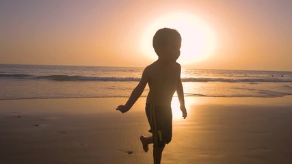 4K Slow motion - A child of 5 years old running freely while the camera chase them