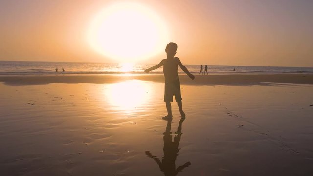 4K Slow motion - A child of 5 years old running freely while the camera chase them