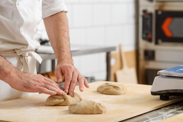 Baker is kneading dough