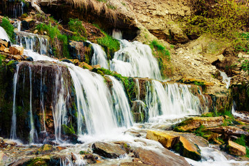 Obraz premium Slovenian Keys waterfall out of the ground. Illuminated source. Living water. Izborsk. Pskov. Russia. Travels.