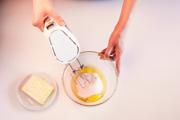 Making dough by female hands on white table