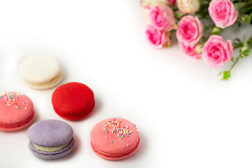  Pink flowers and macaroons on white isolated background.