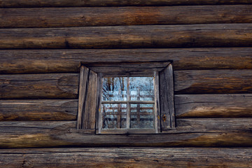 Obraz na płótnie Canvas window with glass in old log in Russia