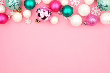 Modern pastel Christmas bauble top border over a light pink background