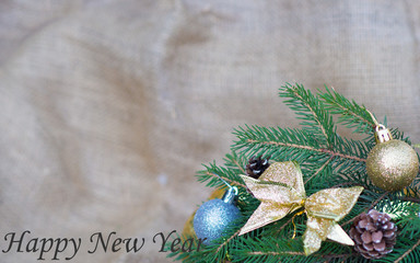  Spruce tree decorated with toys cones on a burlap in the background