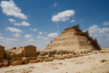 The famous Step Pyramid of Djoser in Sakkara (Saccara) part of the Giza Plateau and necropolis, shown with scaffolding and deep blue sky