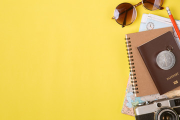 Traveler accessories on yellow background with camera and sunglasses. Top view travel or vacation concept. Flat lay, top view. Summer background. © uinmine