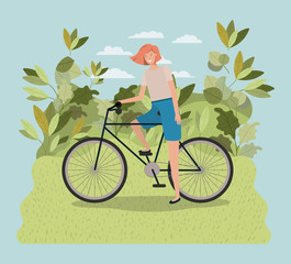 young woman in bicycle on park