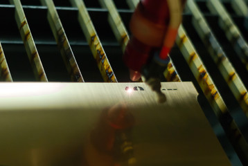 stage of manufacturing, laser engraving in automatic mode, close-up, blurred background