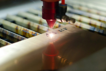 stage of manufacturing, laser engraving in automatic mode, close-up, blurred background