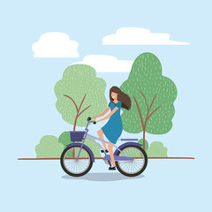 young woman in bicycle on park