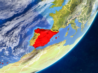Spain on model of planet Earth with country borders and very detailed planet surface and clouds.