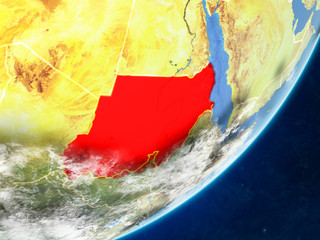 Sudan on model of planet Earth with country borders and very detailed planet surface and clouds.