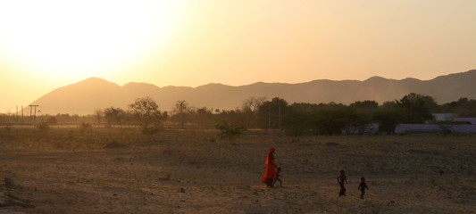 Indian woman with children in the Rajasthan desert