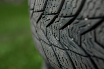 Winter tires close-up . Tires on green background
