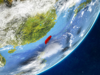 Taiwan on model of planet Earth with country borders and very detailed planet surface and clouds.