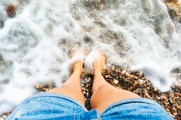 Fototapeta premium female legs in sea foam