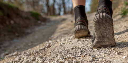 The man runs along the path. Smart Running through the forest. Concept of training, track and field athletics, obstacle race, sports walking