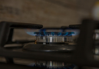 Obraz na płótnie Canvas Fire on the gas stove burner. Burner gas stove, concept of energy. Closeup, selective focus