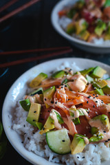 Close-up of California roll sushi bowls on dark background 