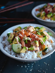 Close-up of California roll sushi bowls on dark background 