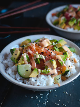 Close-up of California roll sushi bowls on dark background 