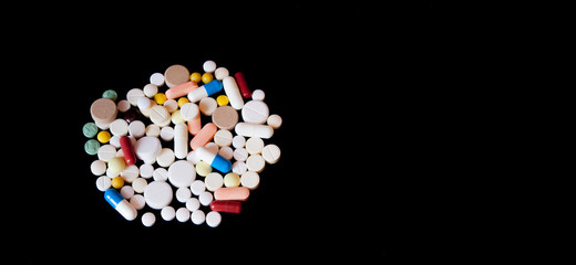 Pharmacy background on a dark table. Levitation pills. Tablets on a dark background which falling down. Pills. Medicine and healthy. Close up of capsules. Pills falling on black background