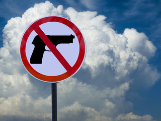 Road sign no gun on sky background with clouds.