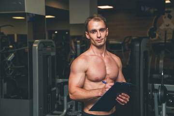 Fototapeta na wymiar Fitness coach portrait at a gym